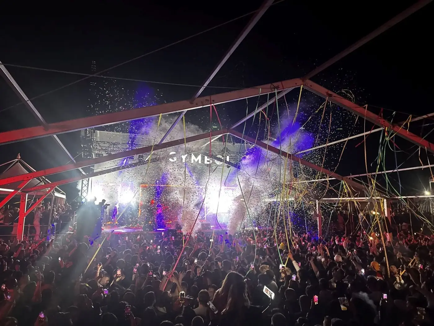 Symbol club stage lights and crowd at night